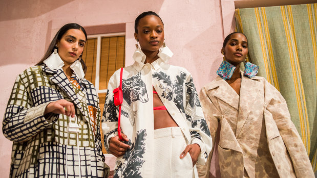 Tiny bags, big splash ... models pose on the runway before the Jacquemus show at Paris Fashion Week (model on far left holds tiny handbag).