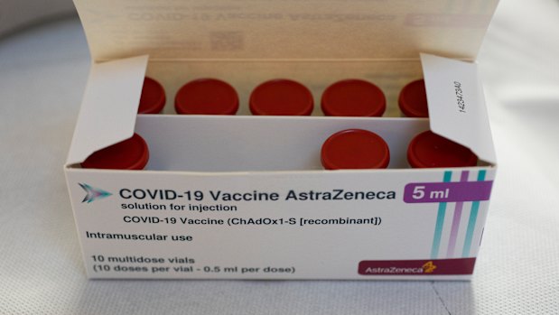 A box with vials of the AstraZeneca vaccine is taken out of a fridge for a few seconds during a vaccination campaign in Amsterdam, Netherlands. 