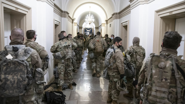 Members of the National Guard assemble in a hallway of the US Capitol building in Washington.