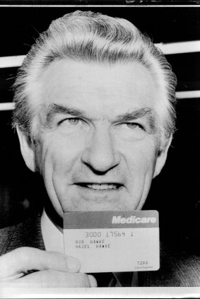 Bob Hawke holds one of the first Medicare cards issued.