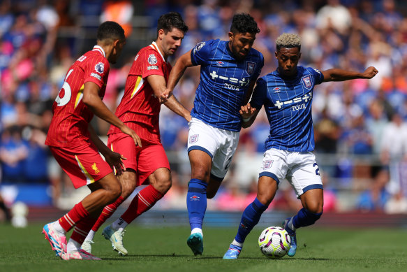 Massimo Luongo and Omari Hutchinson of Ipswich Town battle with Trent Alexander-Arnold and Dominik Szoboszlai of Liverpool in the English Premier League.