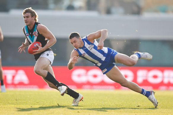 Jason Horne-Francis, left, runs with the ball in Hobart.