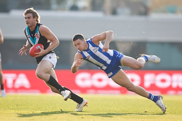 Jason Horne-Francis, left, runs with the ball in Hobart.