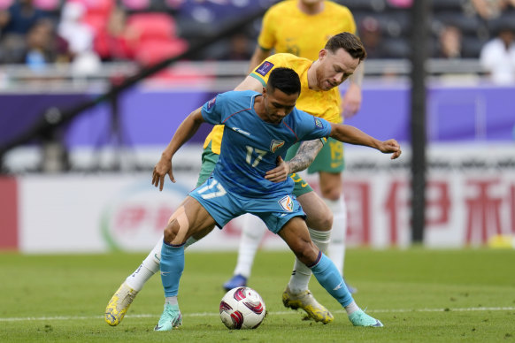 India’s Lallianzuala Chhangte controls the ball as Australia’s Gethin Jones holds him during the Asian Cup Group B soccer match.