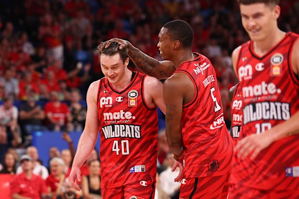 Kristian Doolittle congratulates Elijah Pepper on a career-high 25 points against the Taipans.