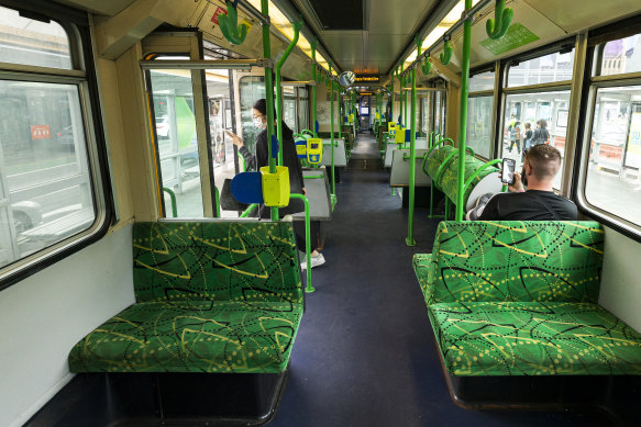 A near-empty tram travels along St Kilda Road.
