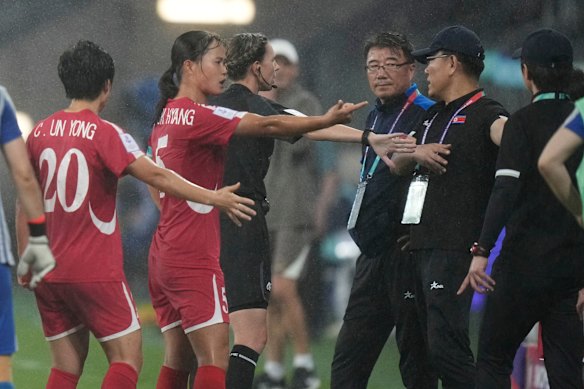 North Korean coaching staff and players argue with a match official after China’s second goal on Monday.