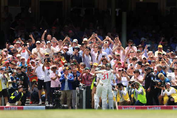 David Warner hugs Steve Smith as he walks off the SCG after being dismissed for a final time in Test cricket.