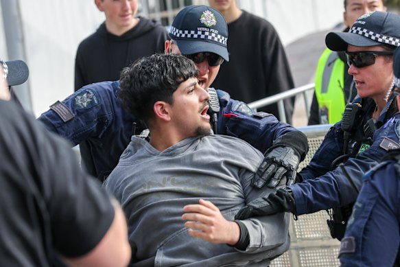 Police intervene at the Federation Square watch party.