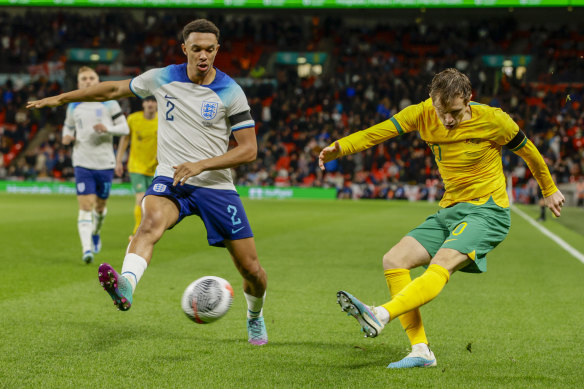 England’s Trent Alexander-Arnold, left, tries to block a shot from Australia’s Craig Goodwin during the international friendly soccer match between England and Australia at Wembley Stadium, London, Friday, Oct. 13, 2023. (AP Photo/David Cliff)