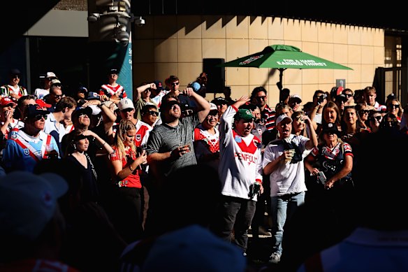 Dragons and Roosters fans play two-up ahead of the Anzac Day clash.