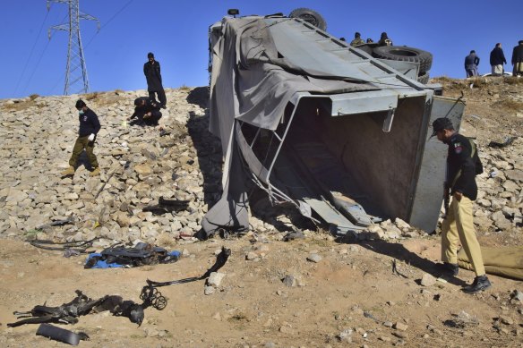 Pakistani security officials inspect a damaged truck at the site of suicide bombing on the outskirts of Quetta, Pakistan, last month. A suicide bomber hit near a truck carrying police officers on their way to protect polio workers outside Quetta.