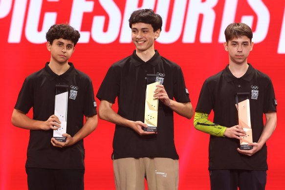 The teen winners of the Olympic esports shooting event take the podium in Singapore: silver winner Alexander “Boltz” Feyzjou (left), champion Lucas “anon” Malissa and bronze winner Andrej “Merstach” Piratov. 