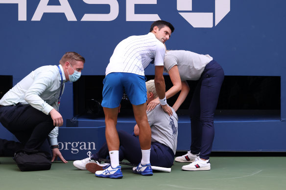 Novak Djokovic tends to a line judge after she was struck by a frustrated strike from the US Open favourite.