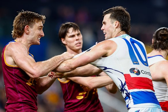 Lions skipper Harris Andrews clashes with Bulldogs star Sam Darcy.