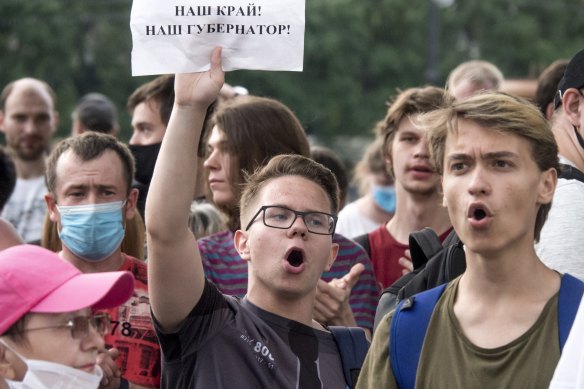 A man holds a poster reading "Our region, our governor!" during an unsanctioned protest in Khabarovsk in Russia.