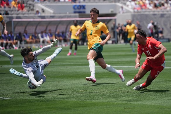 Switzerland forward Dan Ndoye (11) looks on as his shot is blocked by Australia goalkeeper Patrick Beach.