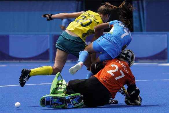 India’s Sharmila Devi collides with Australia’s Karri Somerville and goalkeeper Rachael Lynch.