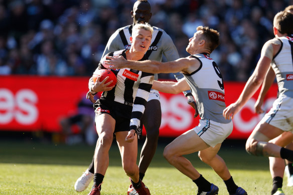 Jack Ginnivan is tackled by Robbie Gray.