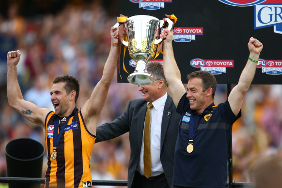 Alastair Clarkson (right) and Hawthorn skipper Luke Hodge hold the 2015 premiership cup aloft. The Hawks have not won a final since.