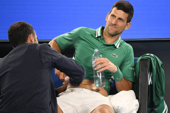 Novak Djokovic receives medical treatment.