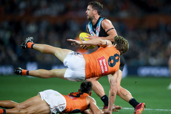 Travis Boak avoids a tackle by Callan Ward.