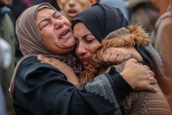 People mourn as they wait to collect the bodies of friends and relatives killed in an airstrike on December 25, 2023 in Khan Yunis, Gaza.