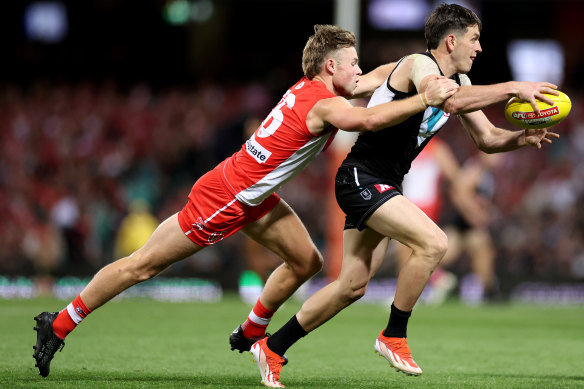 Zak Butters of the Power is tackled by Braeden Campbell of the Swans.