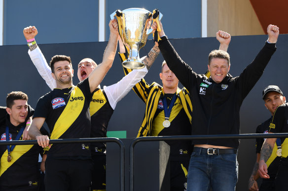 Trent Cotchin and Damien Hardwick lift the cup with Dustin Martin and Jack Riewoldt behind.