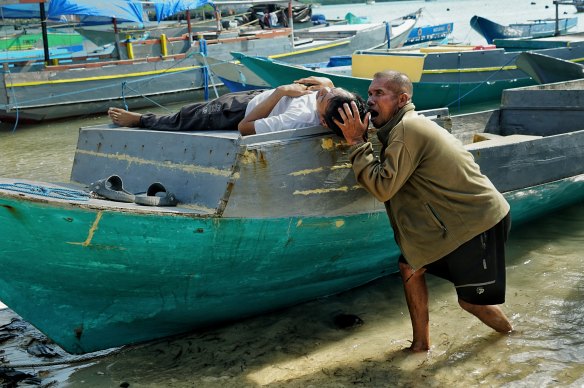 Papela fishermen demonstrate how Laudi was taken by a crocodile.
