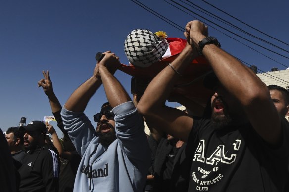 Mourners bring the body of Sohaib al-Sous, 15, to the family home in Beitunia on the outskirts of Ramallah for his funeral. 