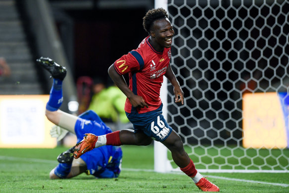 Nestory Irankunda celebrates a goal for Adelaide United against Perth Glory.