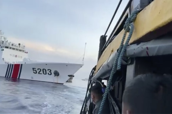 Filipino sailors look after a Chinese coast guard ship with bow number 5203 bumps their supply boat as they approach Second Thomas Shoal.