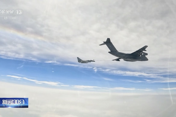 In an image taken from footage run by Chinese television, a Chinese fighter jet performs a mid-air refuelling manoeuvre at an unspecified location.