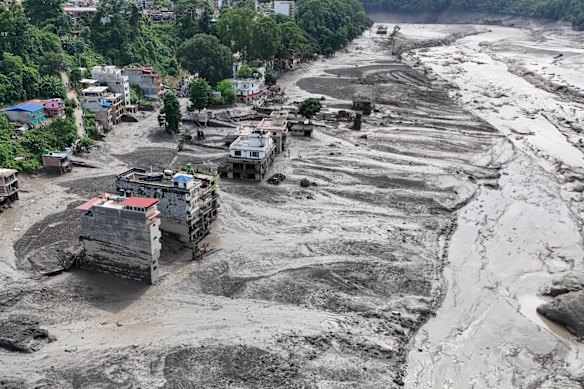 An aerial view shows buildings and infrastructure damaged along the swollen Trishuli River on the Tibetan side of the border with Nepal.