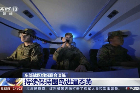 In footage aired on Chinese television, Chinese soldiers manoeuvre inside a ballistic missile launch command centre during a military drill.