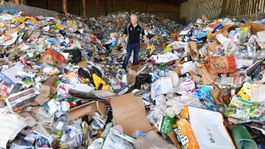 Chris Philp, general manager of Wheelie Waste, amongst a day's worth of Kyneton's recycle rubbish.