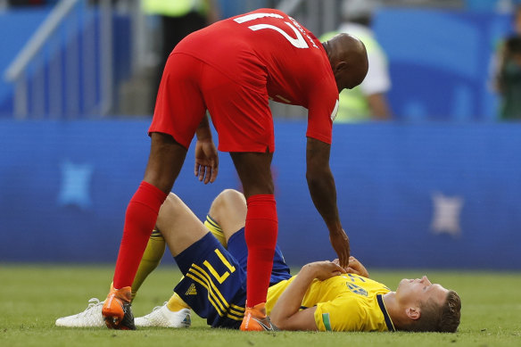 Respect: England's Fabian Delph  comforts Sweden's Viktor Claesson after the quarterfinal match.