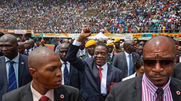 Emmerson Mnangagwa, center, arrives at his presidential inauguration ceremony last year.