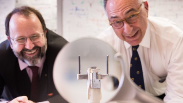Jeffrey Rosenfeld (right) with a 9mm ceramic tile central to the bionic eye project.