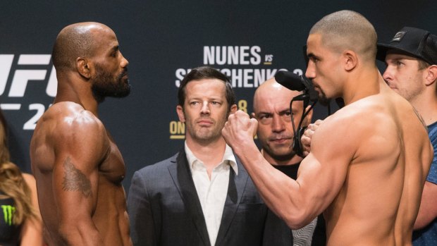 Head to head: Robert Whittaker, right, faces off with Yoel Romero.