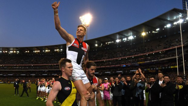 Riewoldt is chaired off the ground by his cousin Jack and teammate Josh Bruce.