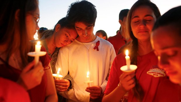 Students gather during a vigil at Pine Trails Park for the victims of Wednesday's shooting at Marjory Stoneman Douglas High School in Florida.