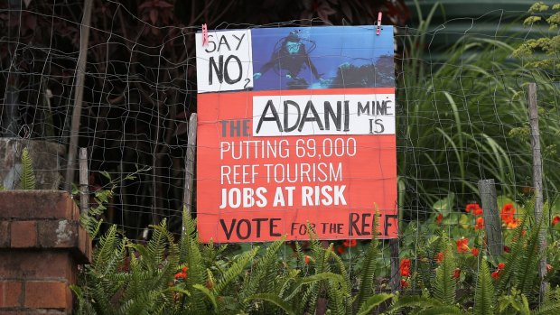 A sign protesting the proposed Adani mine is seen in South Brisbane in the lead-up to the Queensland election.