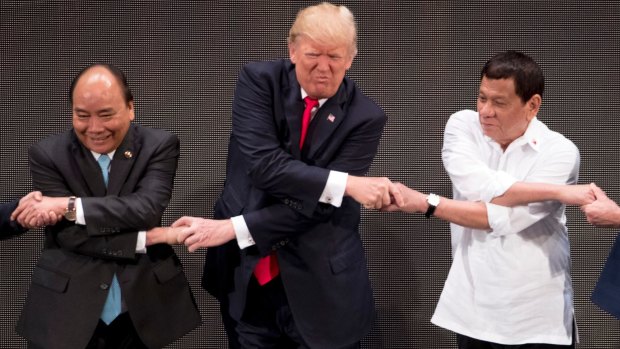 US President Donald Trump does the "ASEAN-way handshake" in Manila last year. The regional grouping is often dismissed but Wong insists it has value.