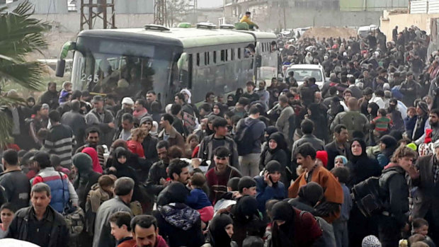 Syrian civilians flee fighting between the government forces and rebels in eastern Ghouta, a suburb of Damascus.