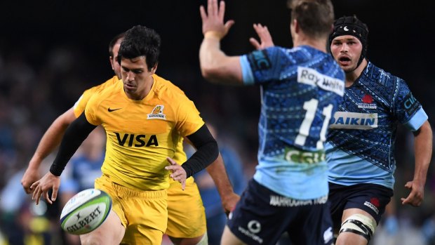 Cheeky: Matias Moroni of the Jaguares chips the ball over Cameron Clark in last year's clash.