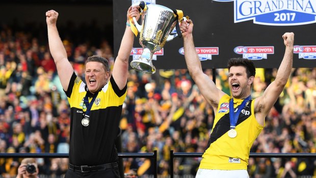 Cotchin and Damien Hardwick celebrate with the cup.