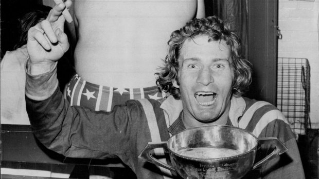 Graeme Langlands, with a cigar in his hand and the Ashes Cup full of champagne in the other, relaxes in the dressing room after leading Australia to their 22-18 win in the third Rugby League Test at the SCG.