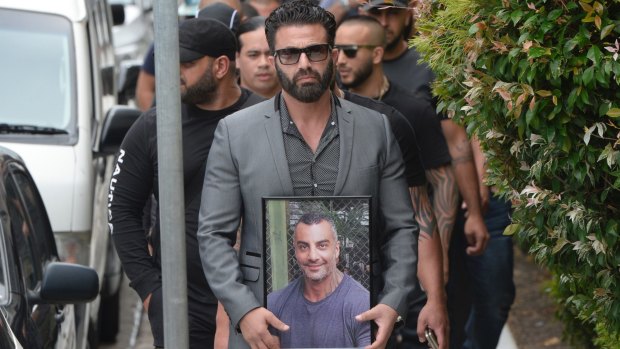 One man carried a framed photo of Mahmoud "Mick" Hawi at the funeral.